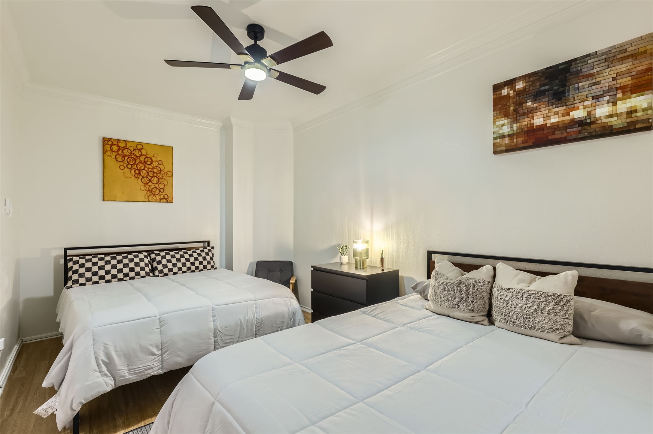 1016 Thackeray Lane Pflugerville, TX 78660 - Photo 13 of 28 Bedroom featuring ornamental molding, wood finished floors, and ceiling fan