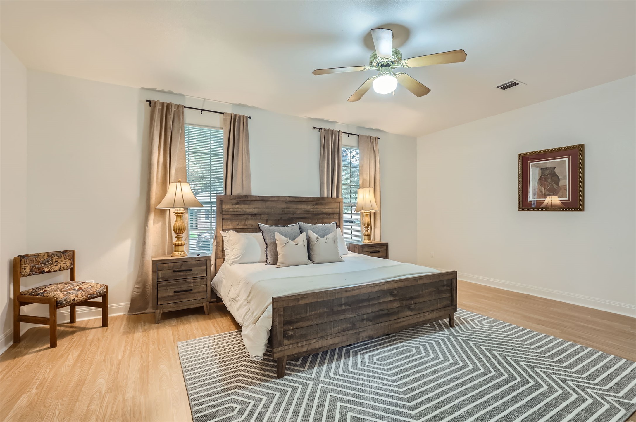 1016 Thackeray Lane Pflugerville, TX 78660 - Photo 15 of 28 Bedroom featuring light wood-style flooring and a ceiling fan