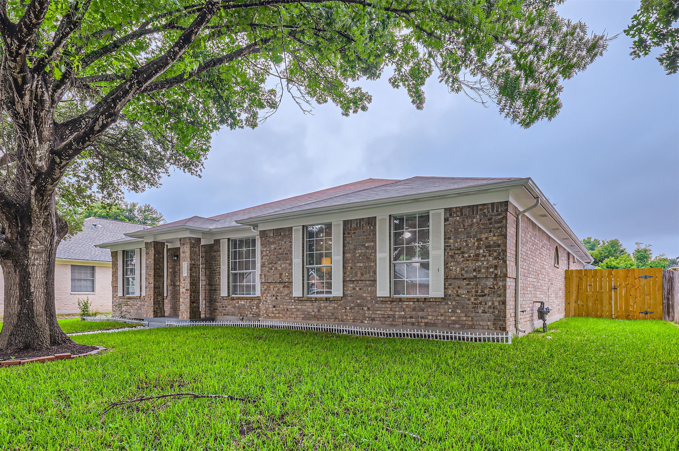 1016 Thackeray Lane Pflugerville, TX 78660 - Photo 2 of 28 Ranch-style home featuring brick siding and a shingled roof