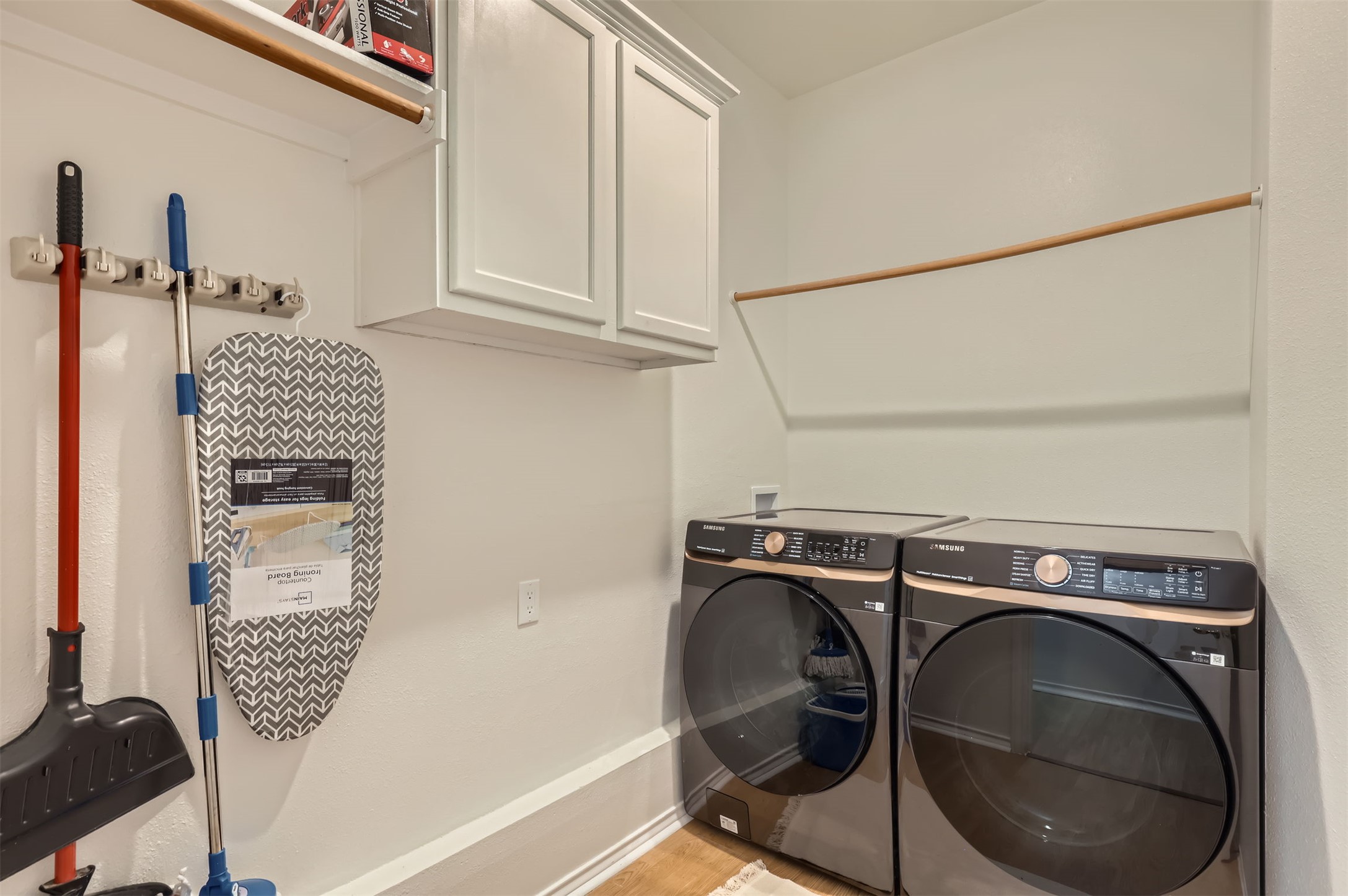1016 Thackeray Lane Pflugerville, TX 78660 - Photo 23 of 28 Laundry room featuring cabinet space, washer and dryer, and light wood-style floors