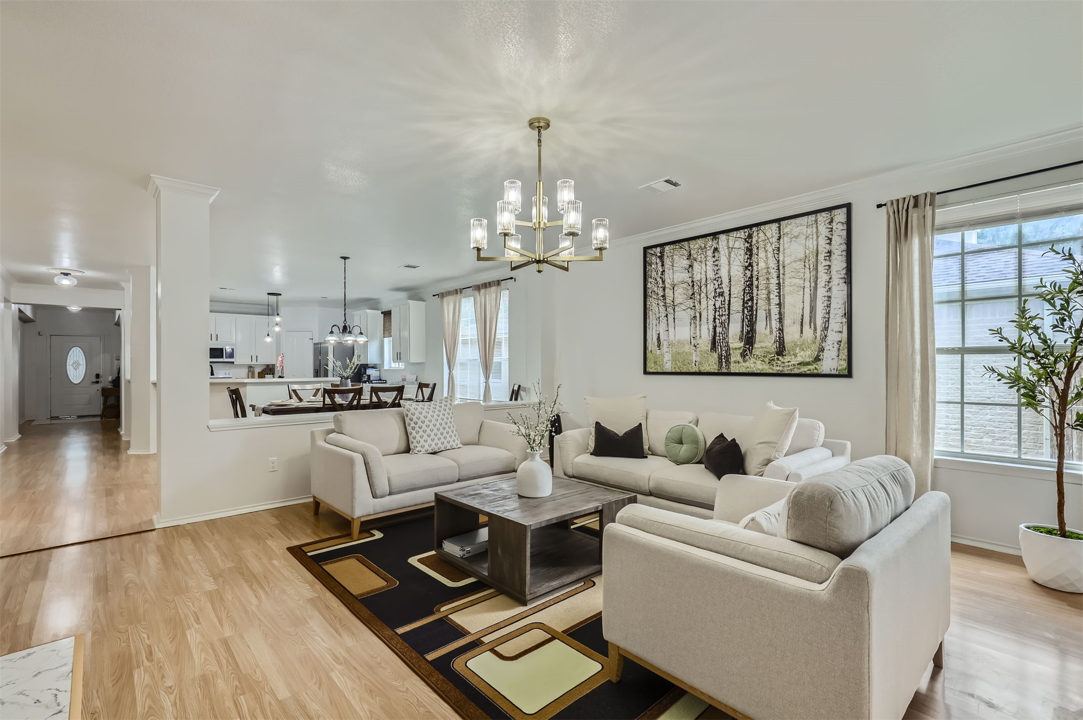 1016 Thackeray Lane Pflugerville, TX 78660 - Photo 5 of 28 Living room with a chandelier and light wood-style floors