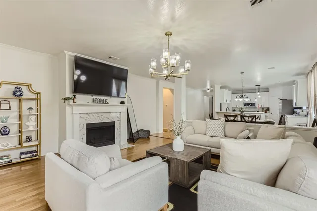 a living room with furniture a flat screen tv and a fireplace
