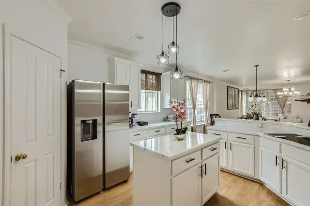 a kitchen with stainless steel appliances a sink stove and refrigerator