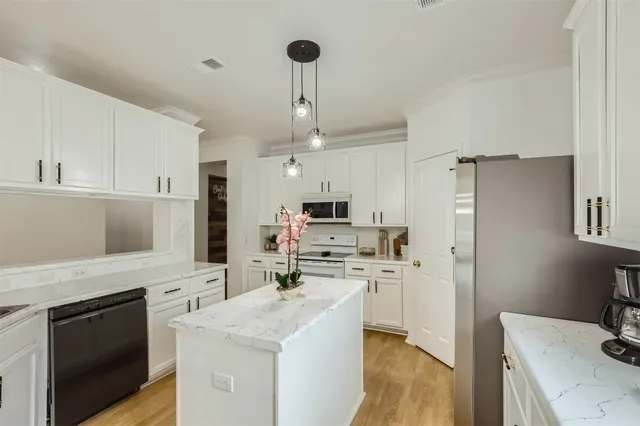 a kitchen with a sink stove and refrigerator