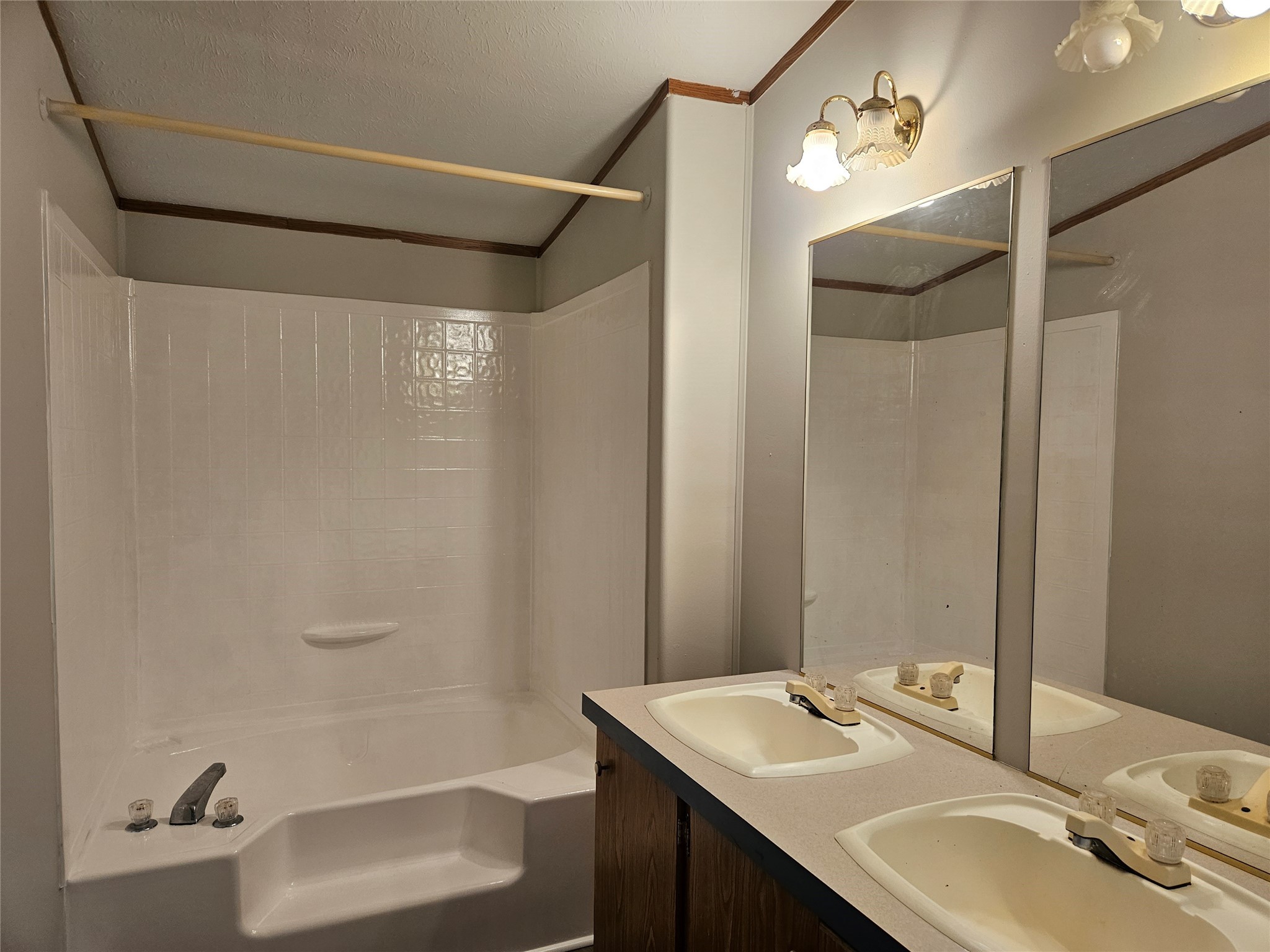 14225 East Ravine Run Willis, TX 77318 - Photo 17 of 27 a bathroom with a sink and mirror with bathtub