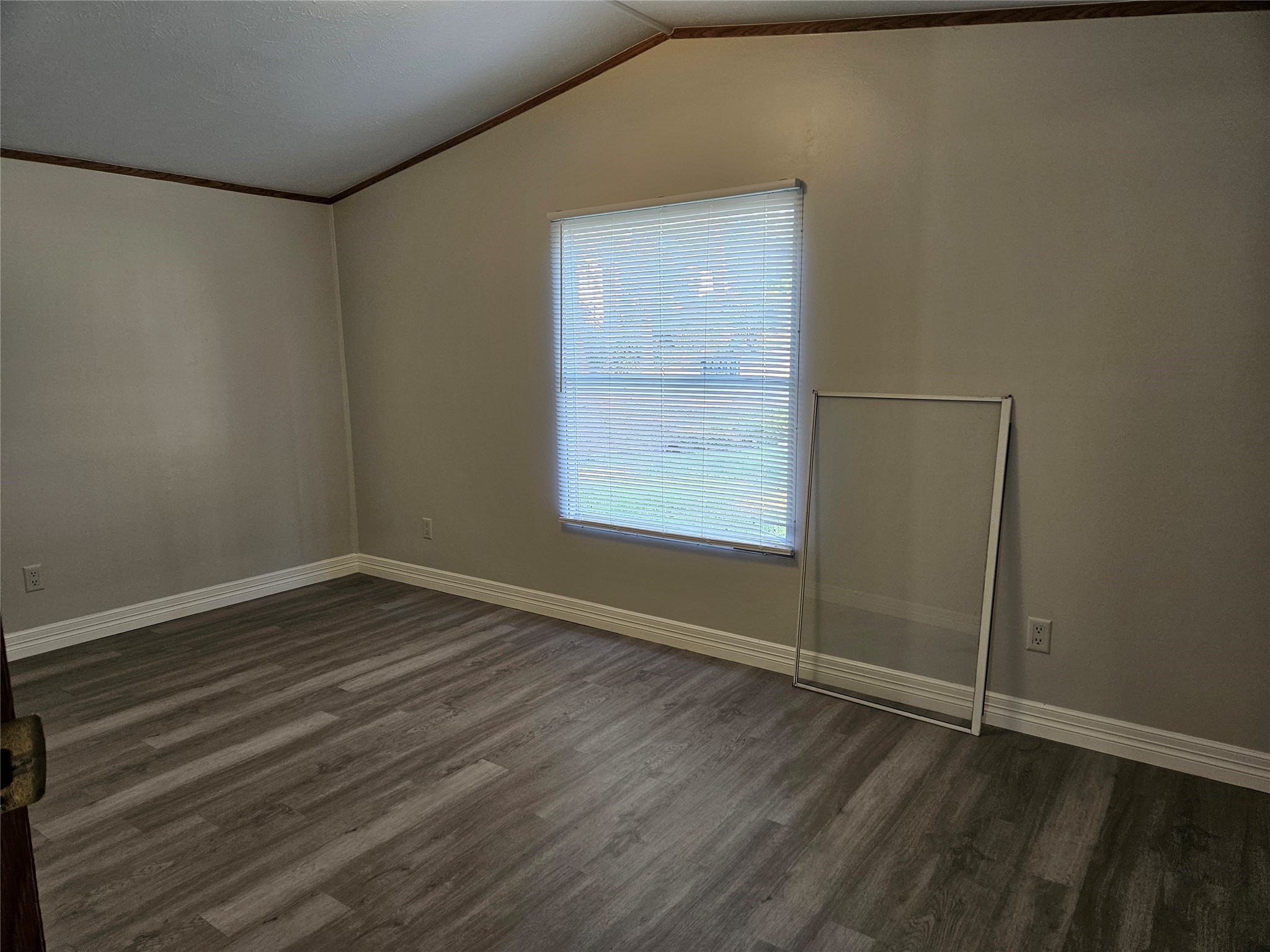 14225 East Ravine Run Willis, TX 77318 - Photo 20 of 27 an empty room with wooden floor and windows