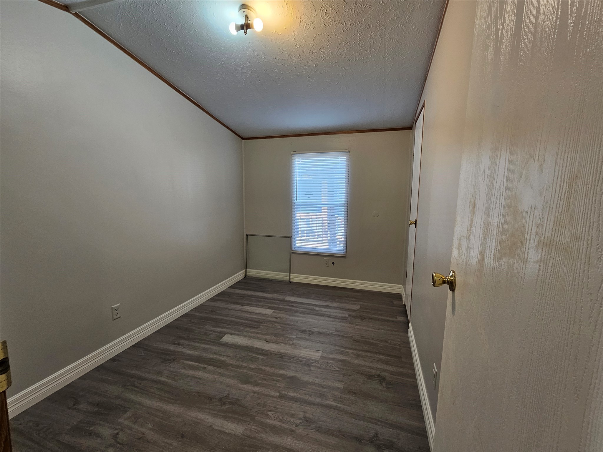 14225 East Ravine Run Willis, TX 77318 - Photo 22 of 27 an empty room with wooden floor and windows