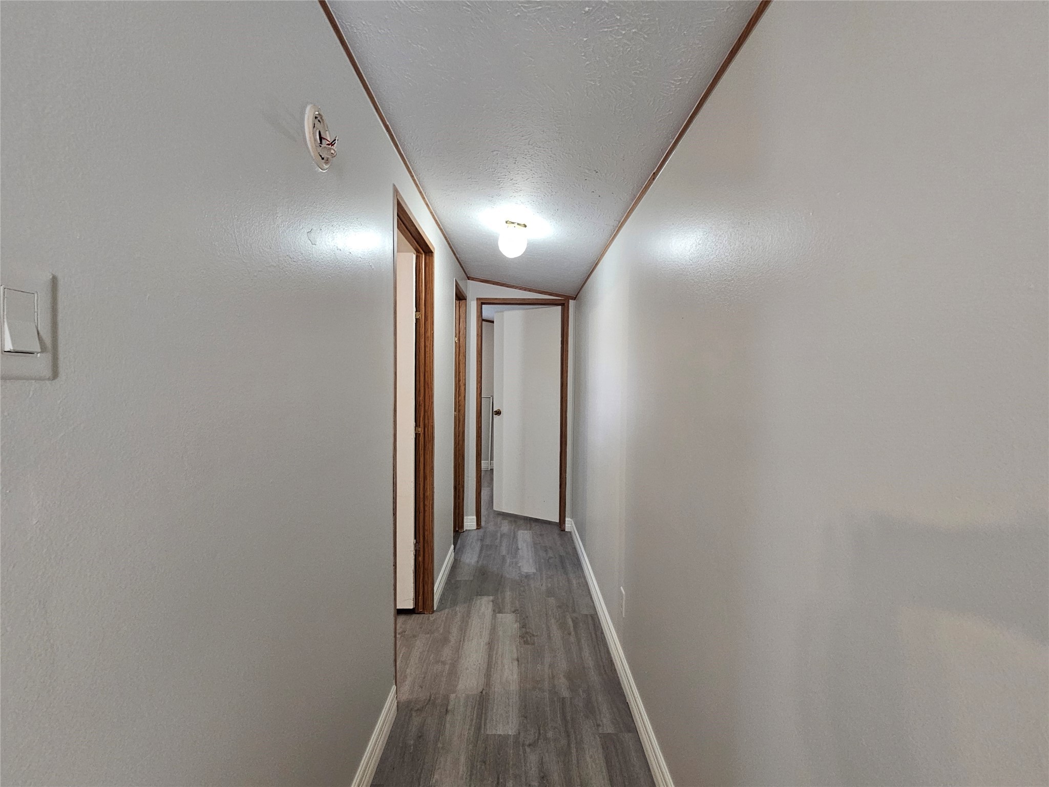 14225 East Ravine Run Willis, TX 77318 - Photo 23 of 27 a view of hallway with wooden floor