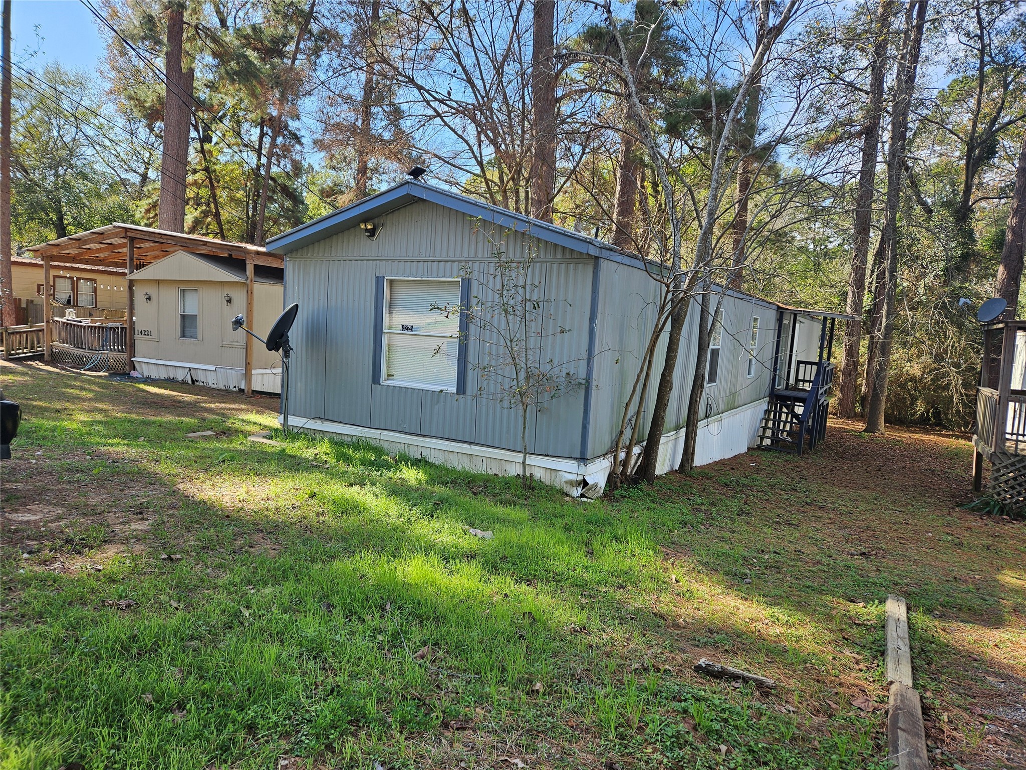 14225 East Ravine Run Willis, TX 77318 - Photo 3 of 27 a house view with a backyard space