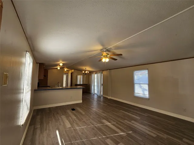 a view of a livingroom with furniture wooden floor and window