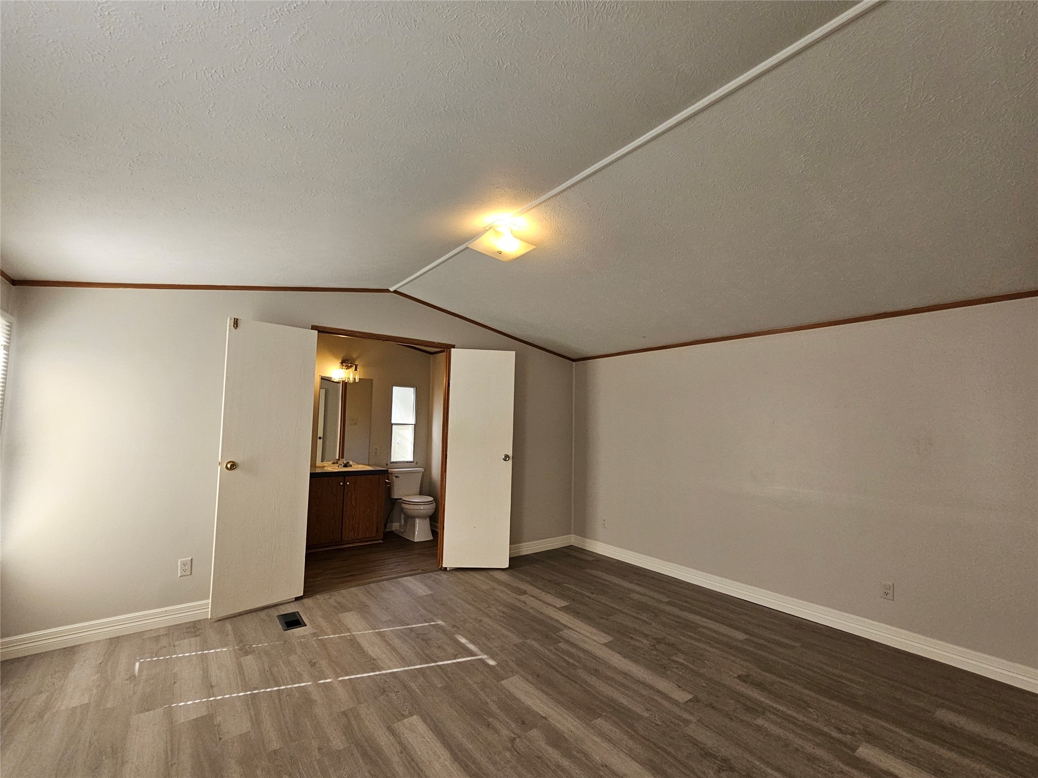 14225 East Ravine Run Willis, TX 77318 - Photo 9 of 27 an empty room with wooden floor and windows