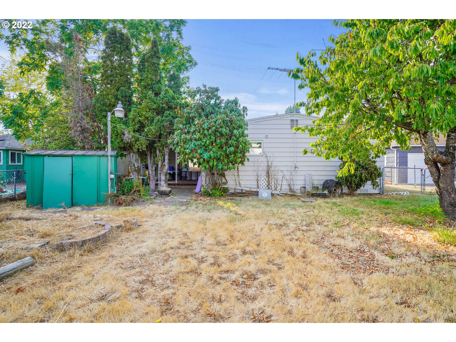 1779 Carroll Street Lebanon, OR 97355 - Photo 22 of 27 a backyard of a house with a garden and plants