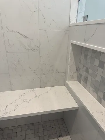 a bathroom with a bathtub and a shower