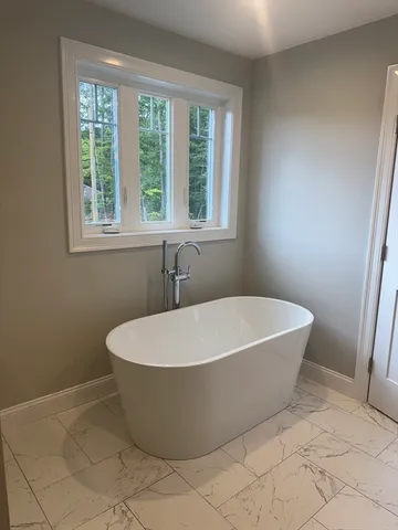a white bath tub sitting in a bathroom