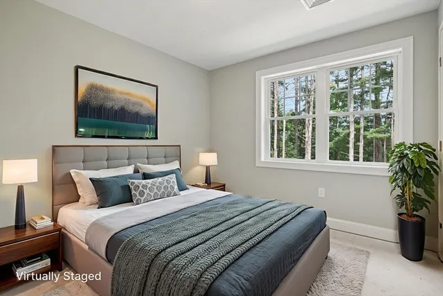 a bedroom with a bed and a painting on the wall