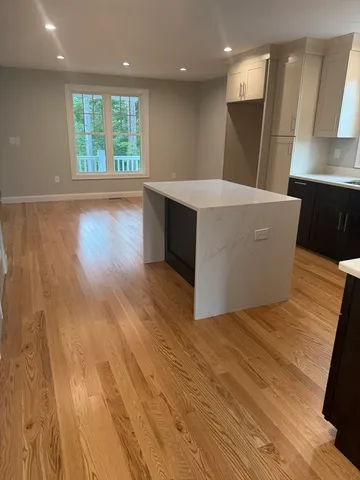 a view of kitchen with wooden floor and a sink