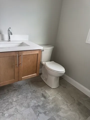 a bathroom with a toilet sink and vanity