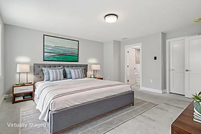 a bedroom with a bed and painting on the wall