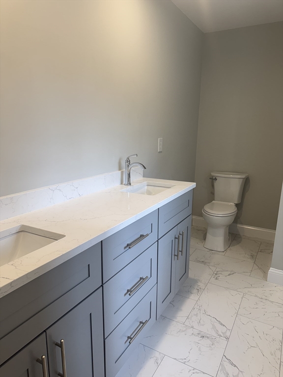 27 James Road, Unit 2 Upton, MA 01568 - Photo 8 of 31 a spacious bathroom with a toilet sink and mirror