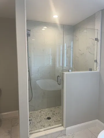 a bathroom with a shower and toilet