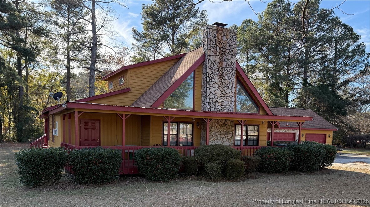 308 Lewis Street Red Springs, NC 28377 - Photo 2 of 18 a front view of a house with garden