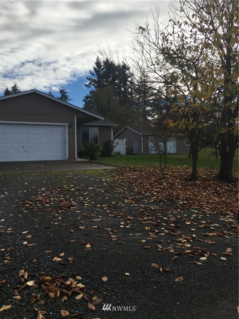 18234 Tamara Lane Southwest Rochester, WA 98579 - Photo 2 of 25 a backyard of a house with lots of green space