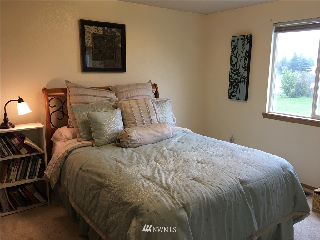 18234 Tamara Lane Southwest Rochester, WA 98579 - Photo 12 of 25 a bed sitting in a bedroom next to a window