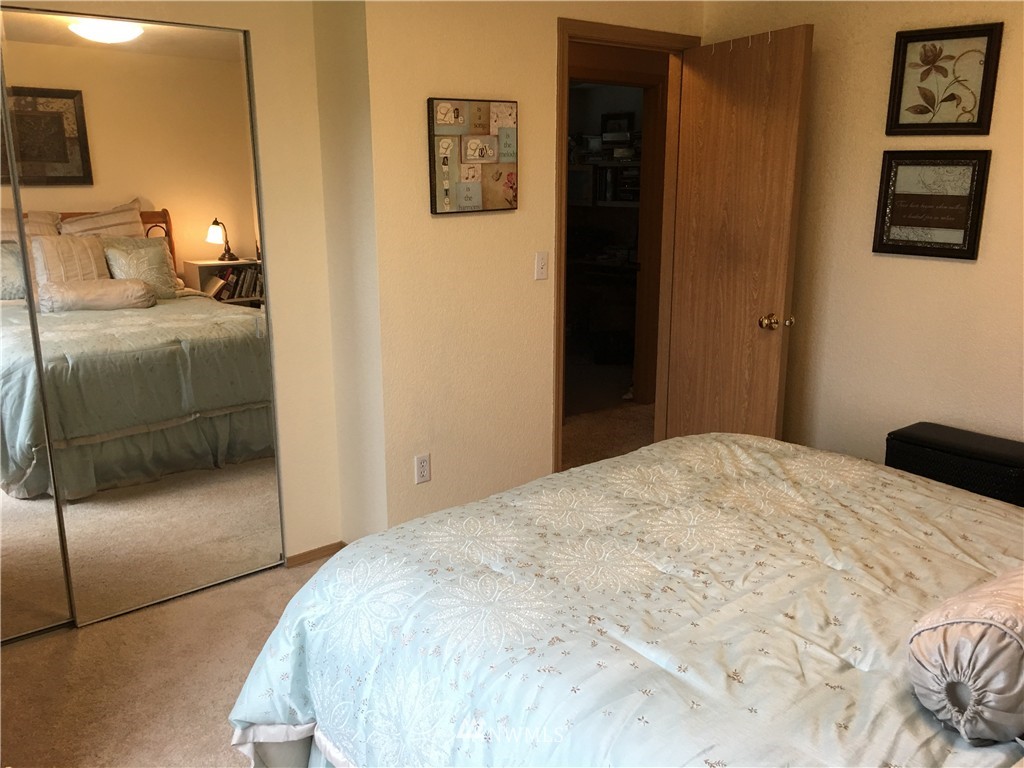 18234 Tamara Lane Southwest Rochester, WA 98579 - Photo 13 of 25 a bedroom with a bed and wooden floor