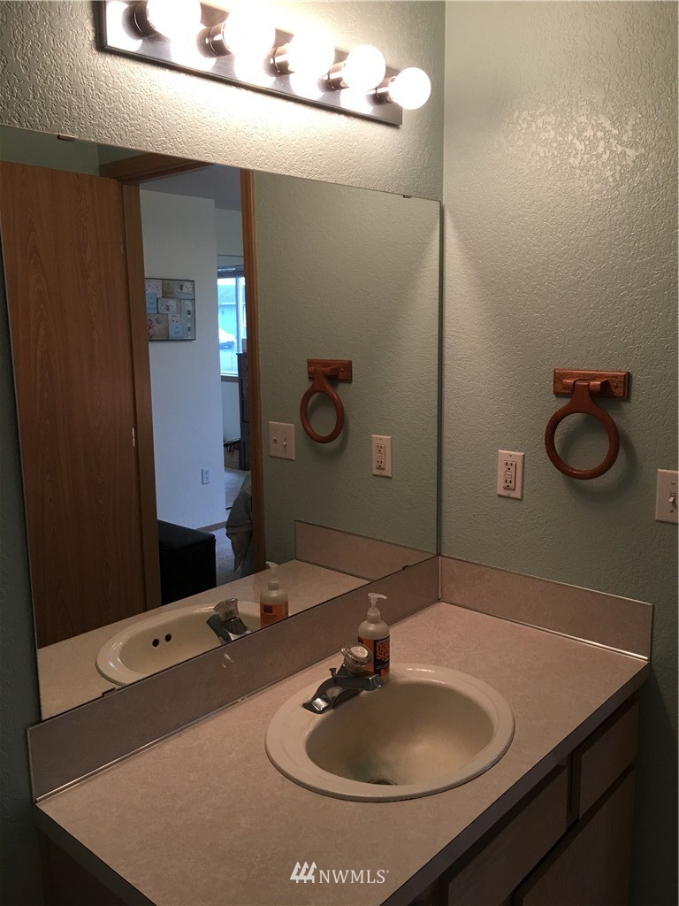 18234 Tamara Lane Southwest Rochester, WA 98579 - Photo 14 of 25 a bathroom with a sink and a mirror