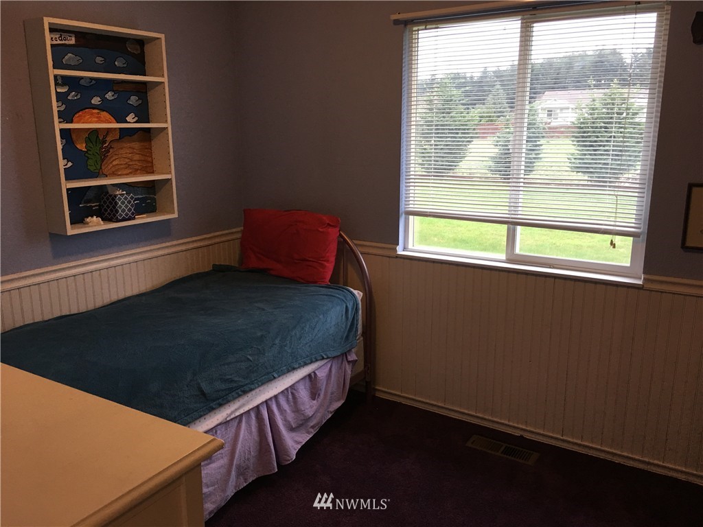 18234 Tamara Lane Southwest Rochester, WA 98579 - Photo 16 of 25 a bed sitting in a bedroom next to a window