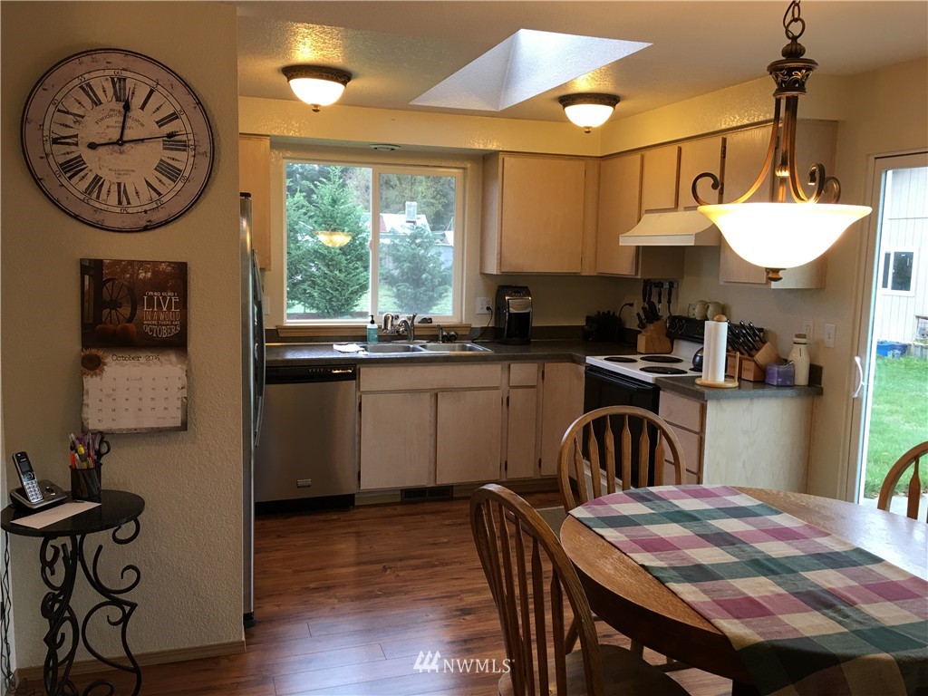 18234 Tamara Lane Southwest Rochester, WA 98579 - Photo 17 of 25 a kitchen with a table chairs sink and cabinets