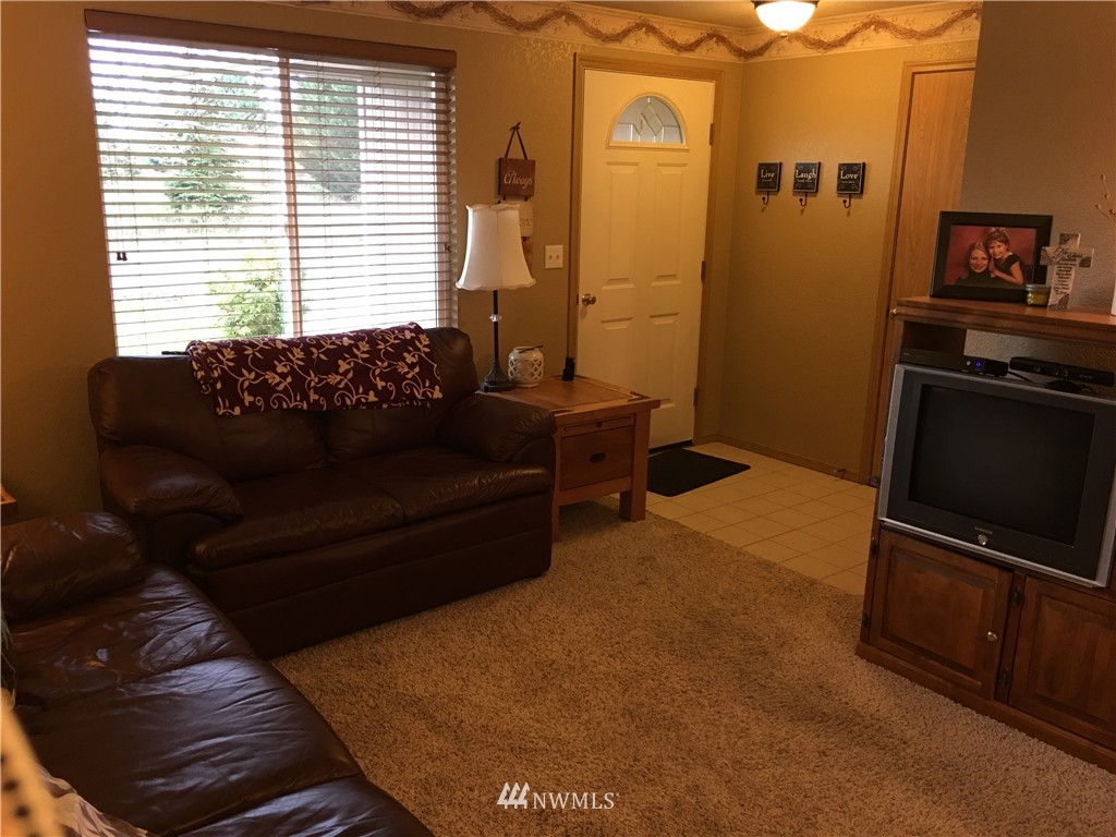 18234 Tamara Lane Southwest Rochester, WA 98579 - Photo 22 of 25 a living room with furniture and a flat screen tv