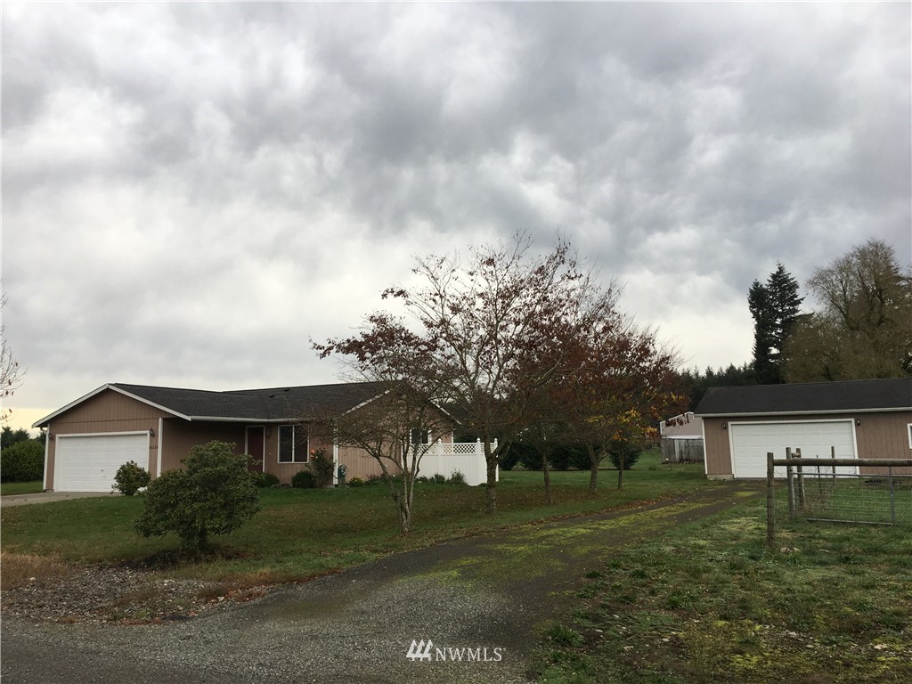 18234 Tamara Lane Southwest Rochester, WA 98579 - Photo 4 of 25 a view of house in front of a big yard with large trees