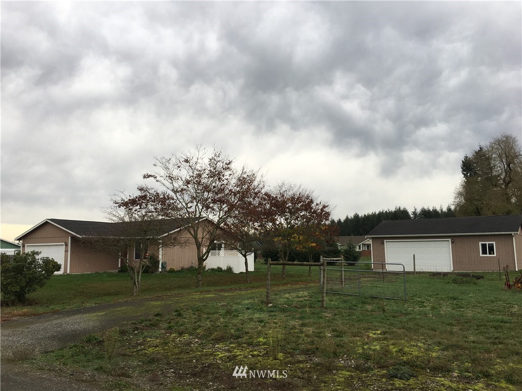 18234 Tamara Lane Southwest Rochester, WA 98579 - Photo 5 of 25 a view of a big house with a big yard and large trees