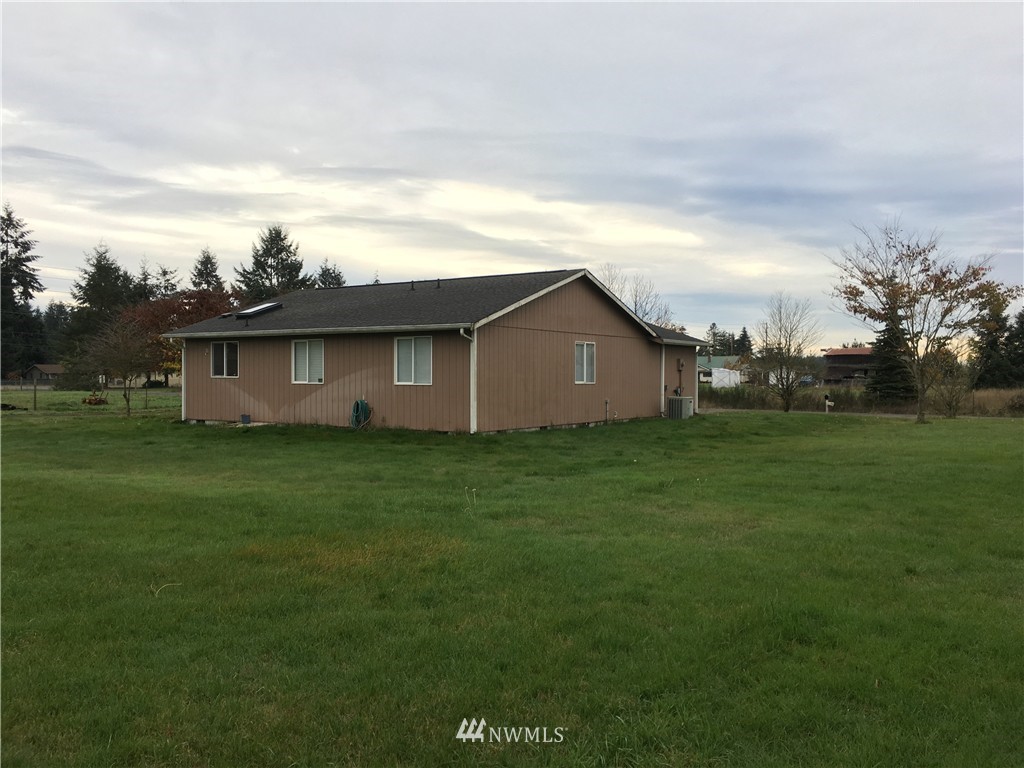18234 Tamara Lane Southwest Rochester, WA 98579 - Photo 6 of 25 a backyard of a house with lots of green space and garden