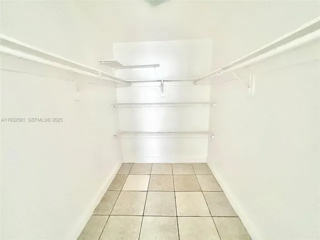 a kitchen with a refrigerator sink stove and cabinets