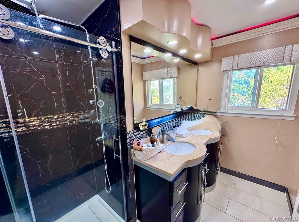 62 Walnut Road Inwood, NY 11096 - Photo 16 of 31 a bathroom with a sink and mirror with bathtub