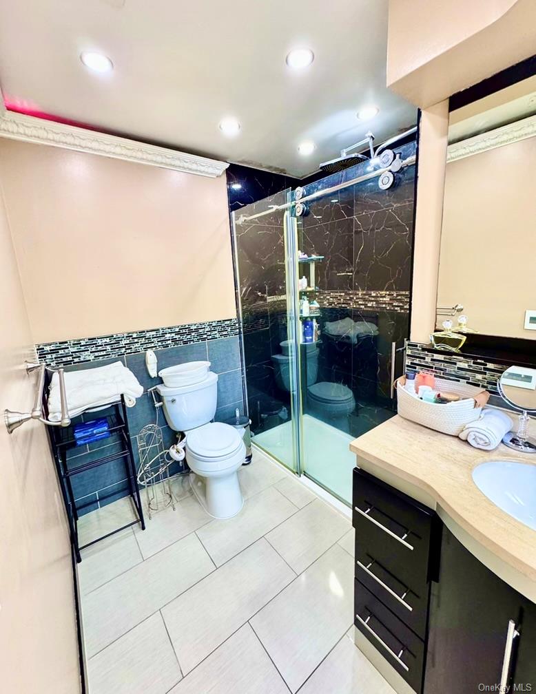 62 Walnut Road Inwood, NY 11096 - Photo 17 of 31 a bathroom with a sink double vanity and a shower