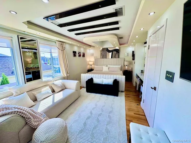 a bedroom with furniture and a large window