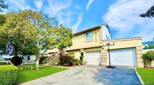 a view of a house with a yard and tree