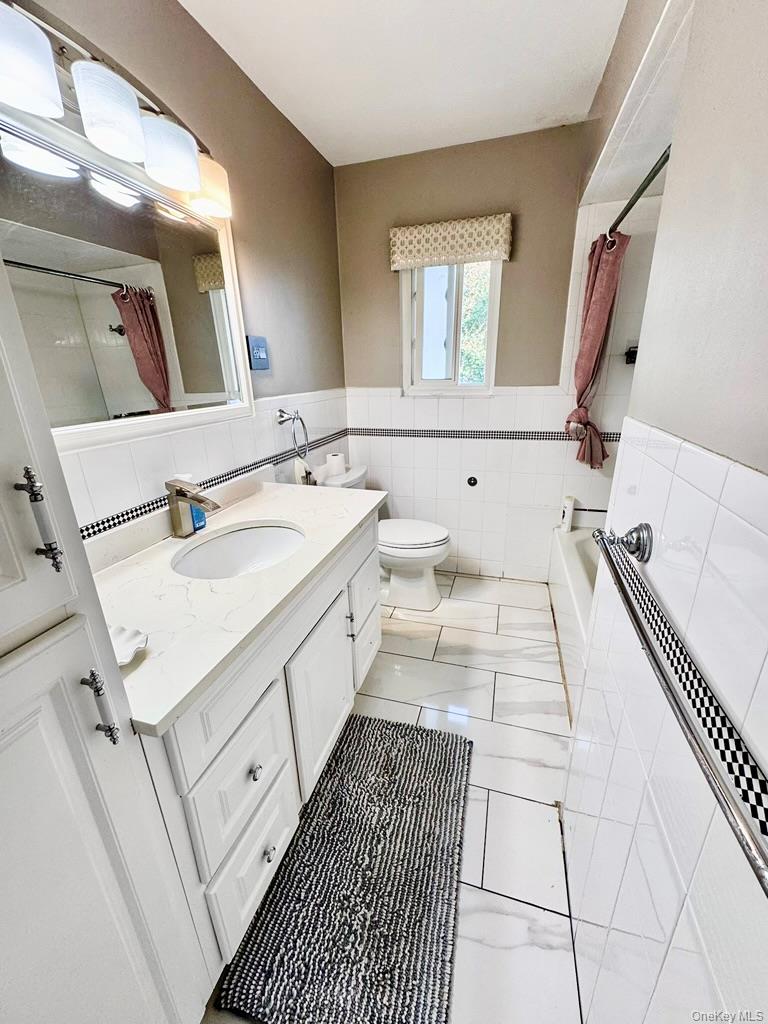 62 Walnut Road Inwood, NY 11096 - Photo 23 of 31 a bathroom with a sink mirror and vanity