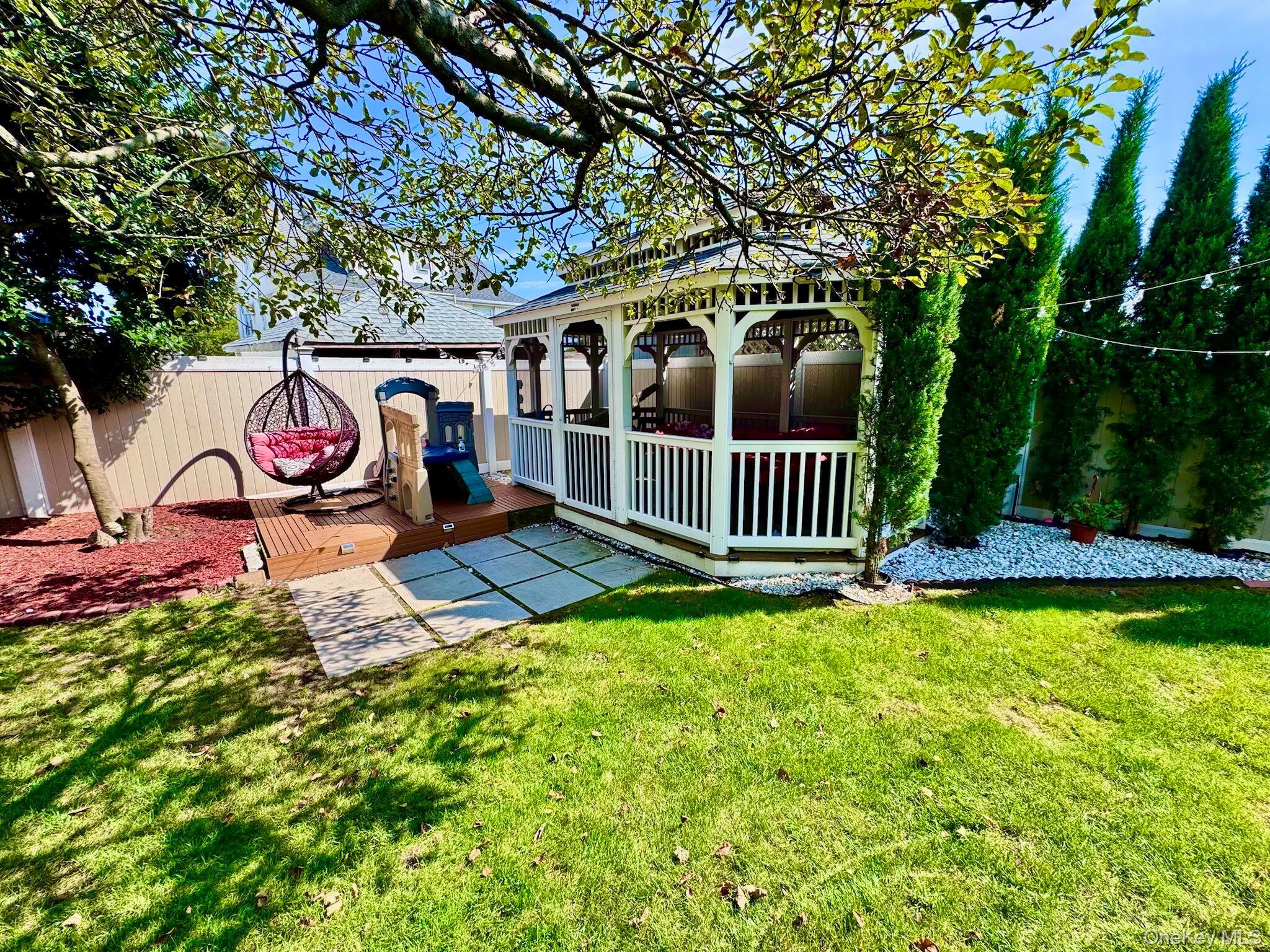 62 Walnut Road Inwood, NY 11096 - Photo 6 of 31 a view of a bench in the garden