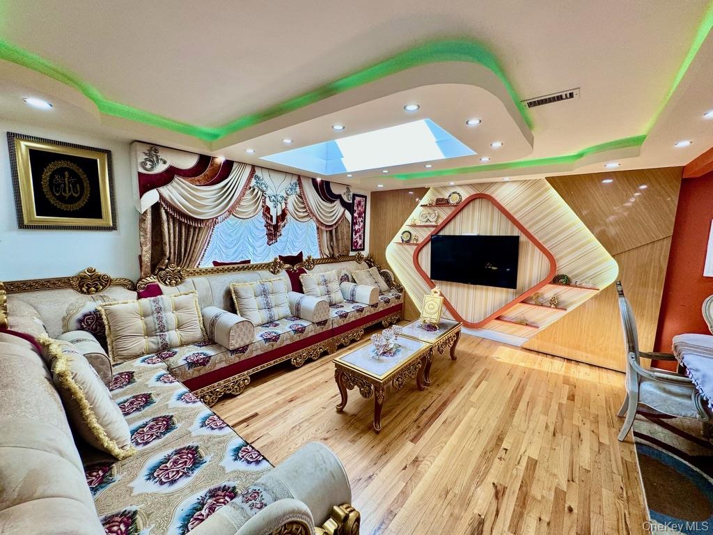 62 Walnut Road Inwood, NY 11096 - Photo 9 of 31 a living room with furniture and a flat screen tv