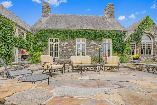 a view of a patio with a dining table and chairs with a fire pit and a fire pit