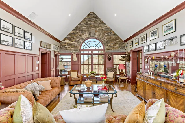 a living room with lots of furniture and a large window