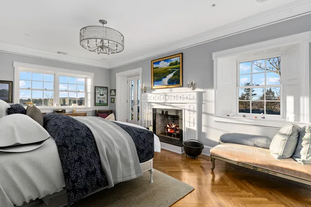 a spacious bedroom with a bed and a fireplace