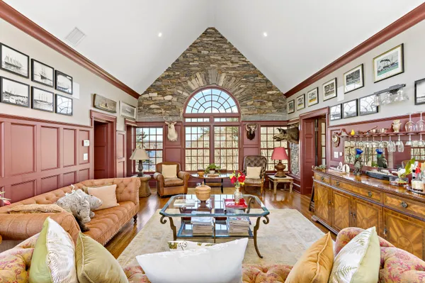 a living room with lots of furniture and a large window