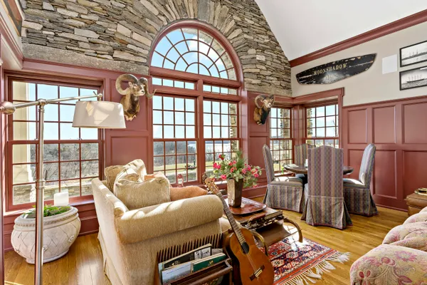 a living room with furniture and a floor to ceiling window