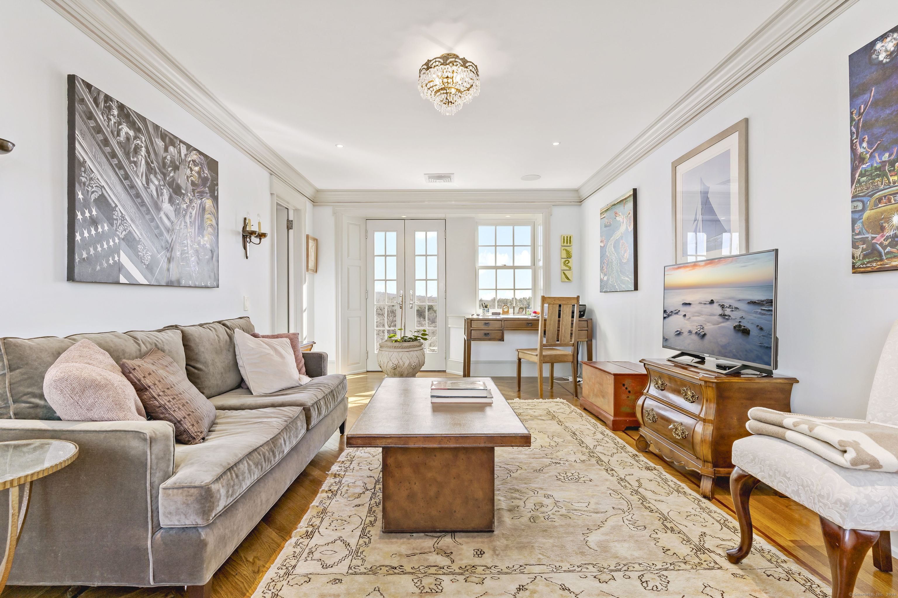 153 Ferry Road Lyme, CT 06371 - Photo 25 of 32 a living room with furniture and a chandelier