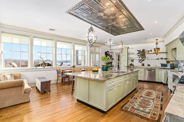 a large kitchen with lots of counter top space and stainless steel appliances